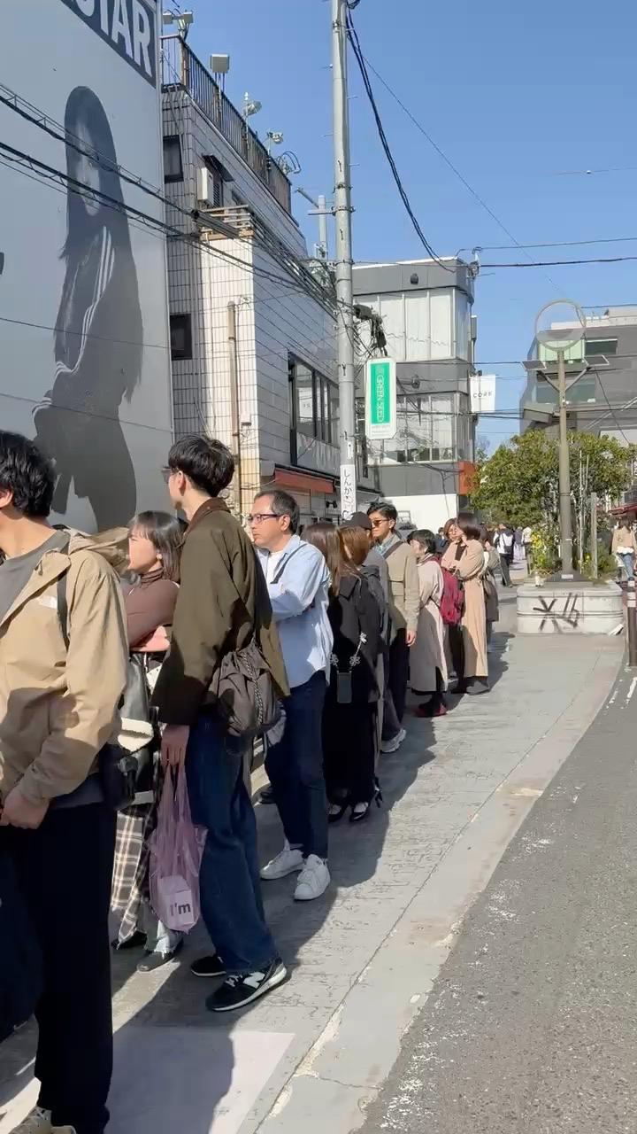 Long line of consumers waiting outside the Adidas Superstar pop-up in Harajuku